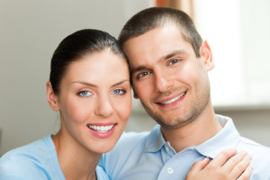 Young smiling attractive couple at home